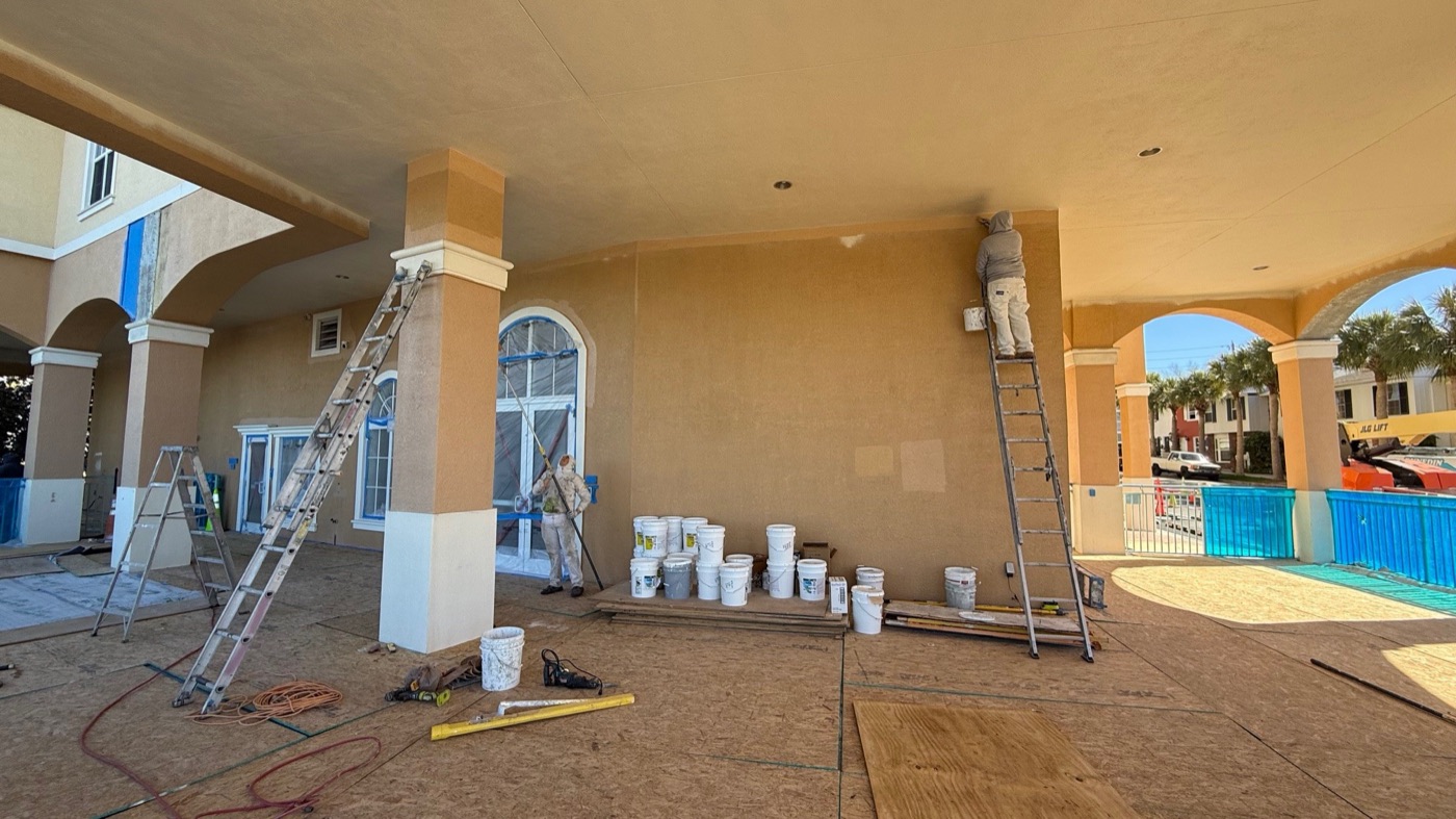 Painting crew repainting the covered entry and columns at the Bayview condo building